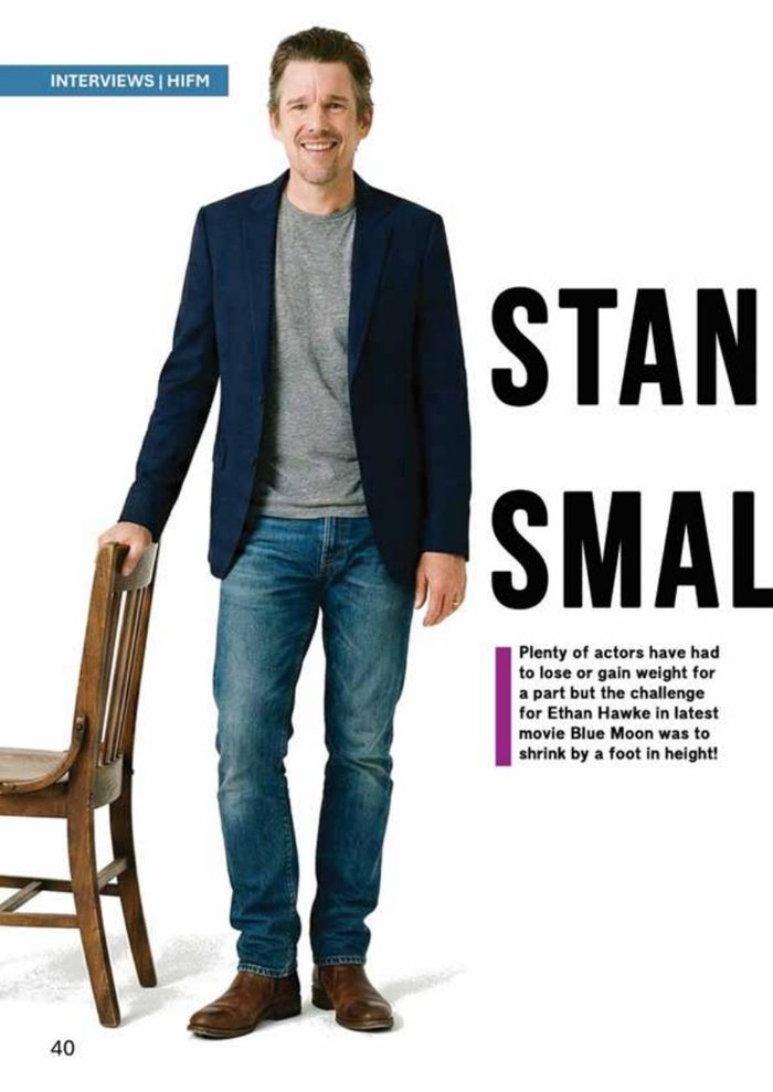 Ethan Hawke standing beside a tall chair
