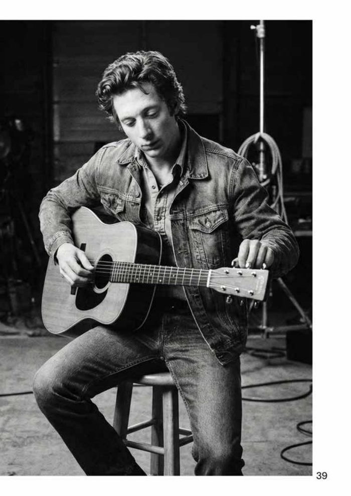 Black-and-white photo of an actor playing guitar